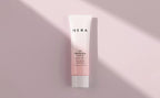 HERA UV Protector Tone-Up sunscreen tube with SPF 50 and pink gradient packaging on pale pink background