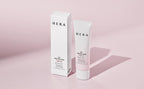 HERA UV Protector Tone-Up sunscreen SPF 50 PA+++ tube and box on pink background