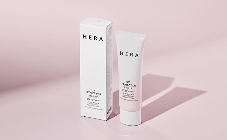 HERA UV Protector Tone-Up sunscreen SPF 50 PA+++ tube and box on pink background