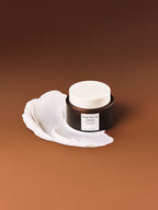 Madagascar Centella Probio-Cica Enrich Cream 50ml in jar with cream smear on brown background