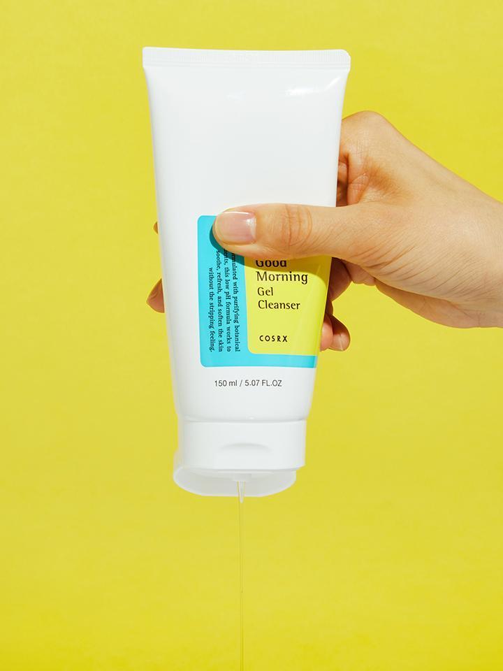 Low pH Good Morning Gel Cleanser 150ml being held, featuring low pH gel cleanser for gentle skin care.